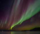 Iceland. Northern Lights over fjord Isafjardardjup near Isafjordur view towards Hornstrandir. Art Print
